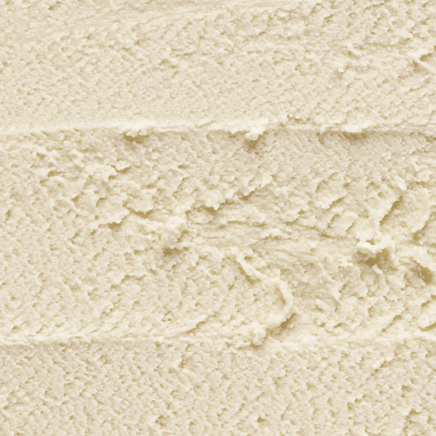 A cream-colored makeup cleansing balm stick swatch with a textured surface of Daily Dose a cosmetic vegan Italian brand