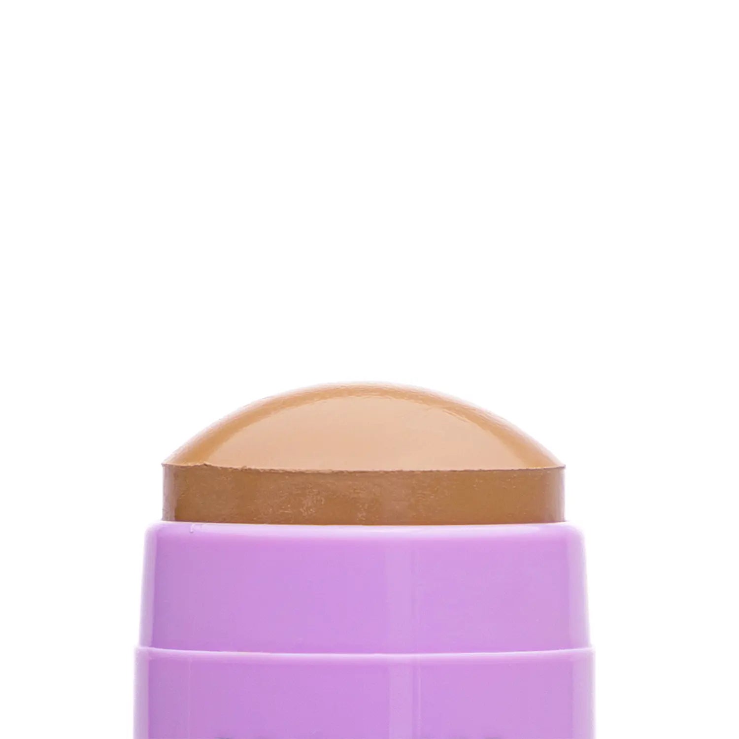 Close-up of a cosmetic Italian vegan makeup bronzer stick named OFC bronze-colored swatch with a textured surface. Daily Dose.