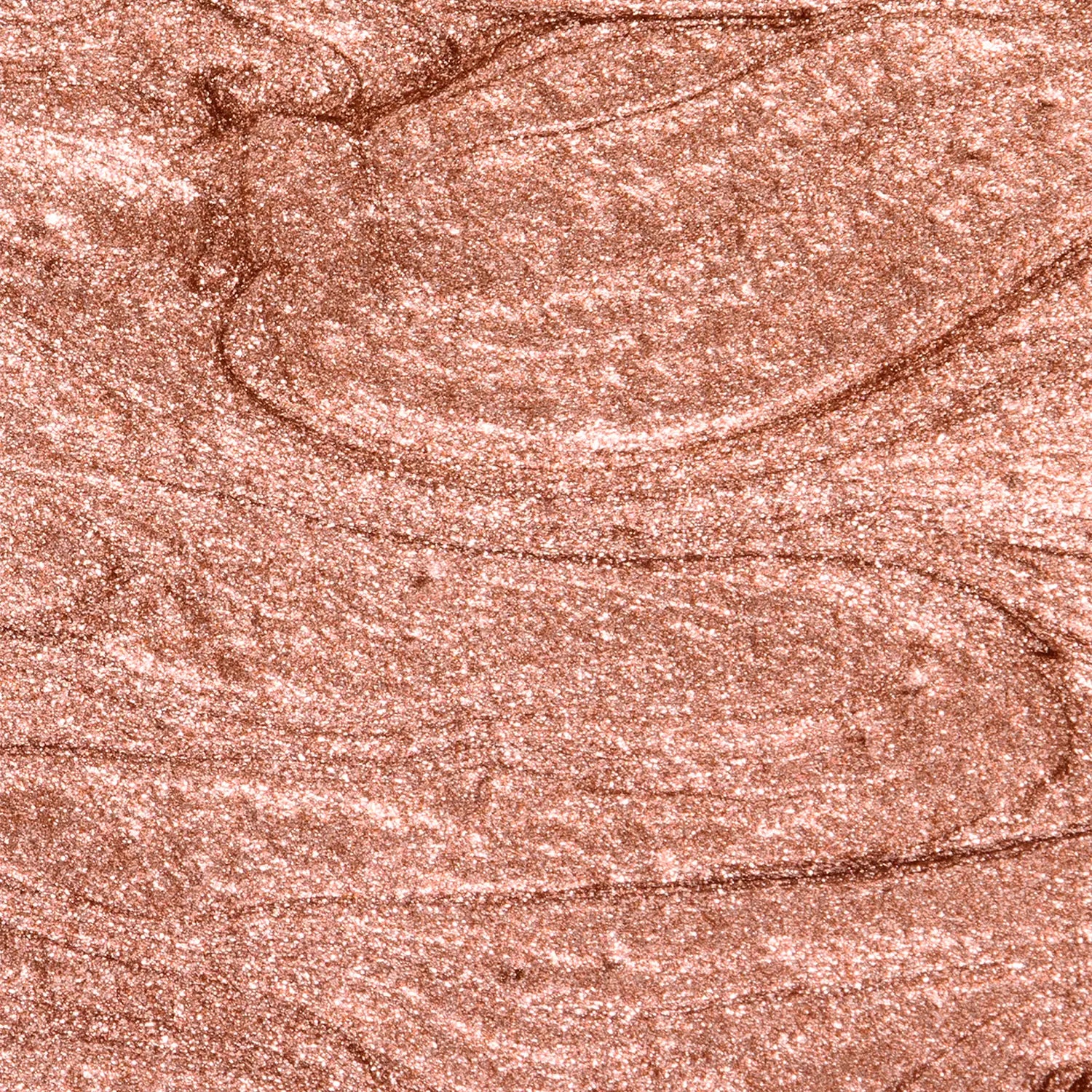 A bronze-colored makeup swatch with a textured surface of Daily Dose a cosmetic Italian vegan highlighter stick named DELULU.