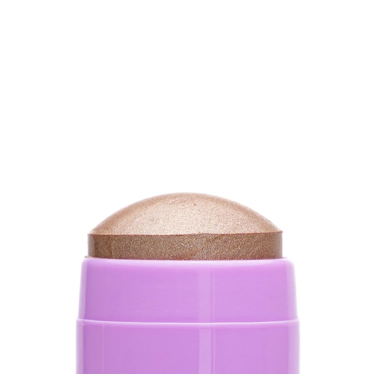 Close-up of a cosmetic Italian vegan highlighter stick named LOL bronze-colored makeup swatch with a textured surface.